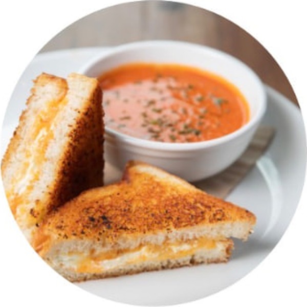 A grilled cheese sandwich and bowl of tomato soup